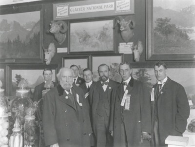 Bearded James J. Hill (left) and Louis W. Hill (center) in front of John Fery landscapes and, in the center, three 1910 Charles M. Russell paintings: (upper center clockwise) A Mix Up, Trouble Hunters, and A Doubtful Handshake, 1911. Courtesy of the Big Sky Collection, Larry and LeAnne Peterson.
